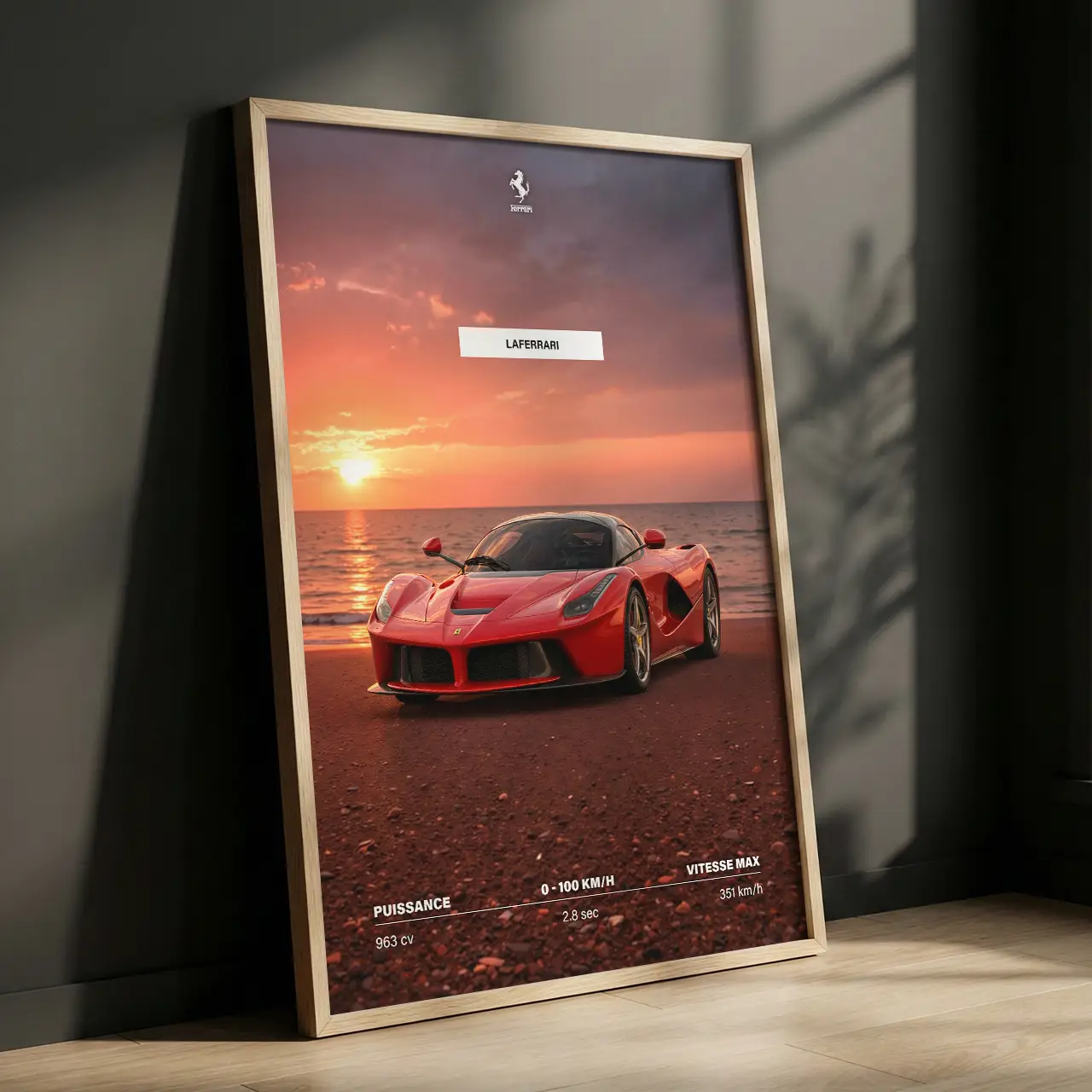 Affiche Ferrari LaFerrari encadrée posée au sol mur gris sombre.